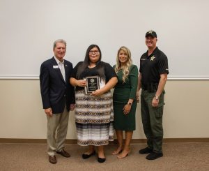 Immokalee Foundation Board Chair Jerry Belle, Academy graduate Mariceliah Cruz, Immokalee Foundation President and CEO Noemi Y. Perez, and Captain Chris Gonzales from the Collier County Sheriff's Office