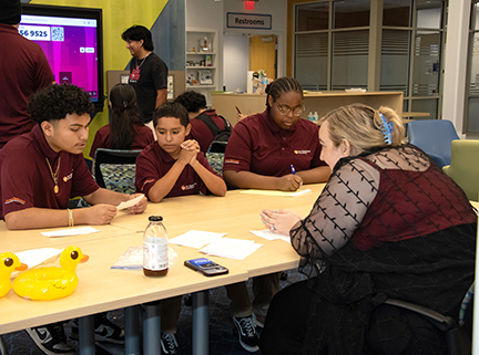 Students discuss their marketing ideas with an FGCU instructor